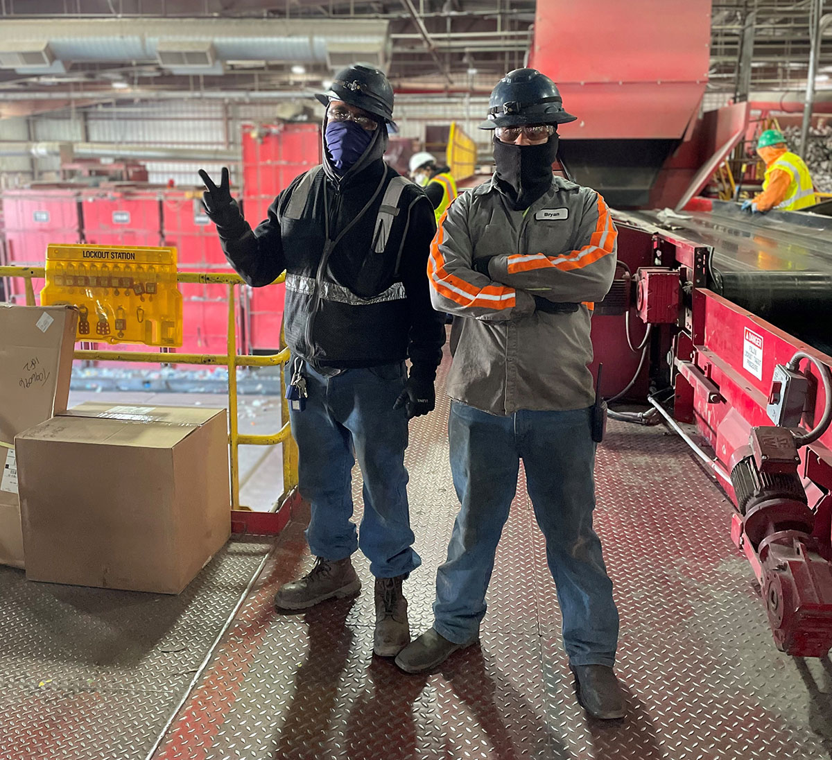 Two employees posing at recyling center